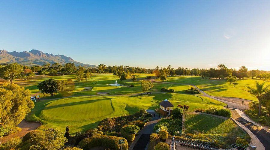 Stellenbosch Golf Club fairways and clubhouse grounds with mountains at golden hour