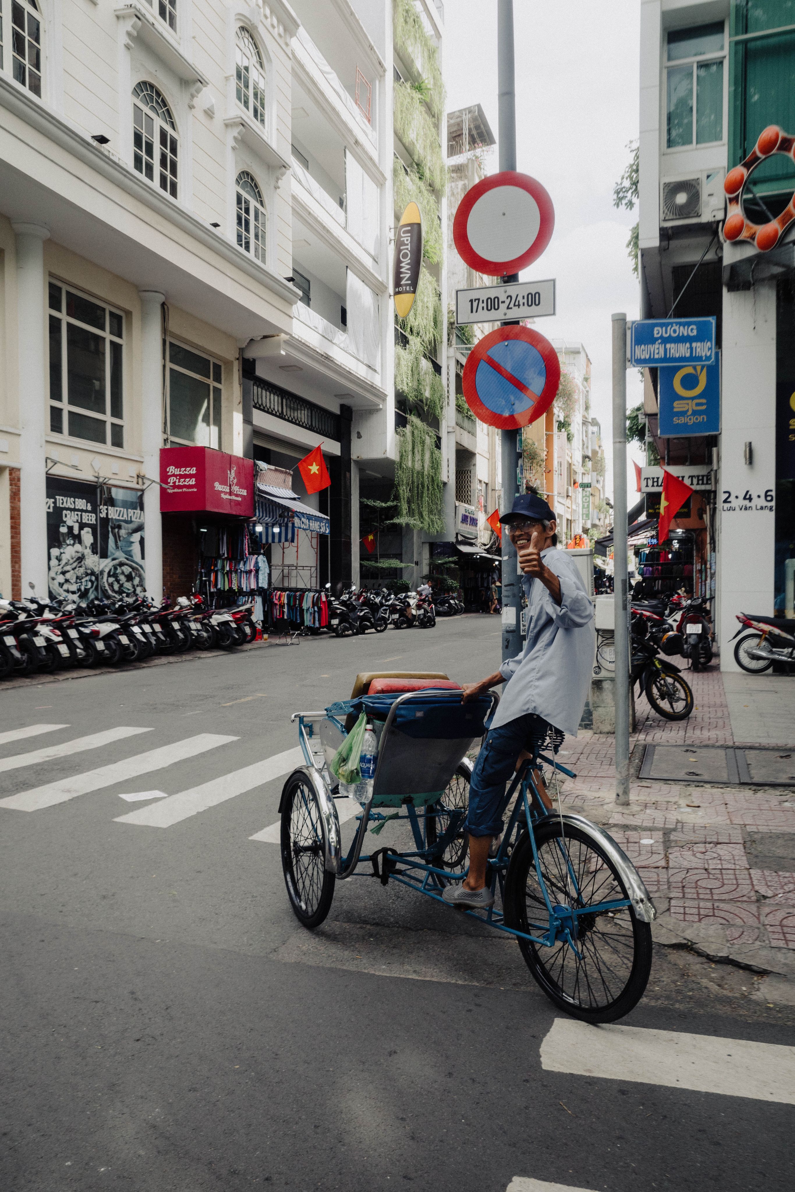 Cyclo driver giving a thumbs up on a street in Vietnam
