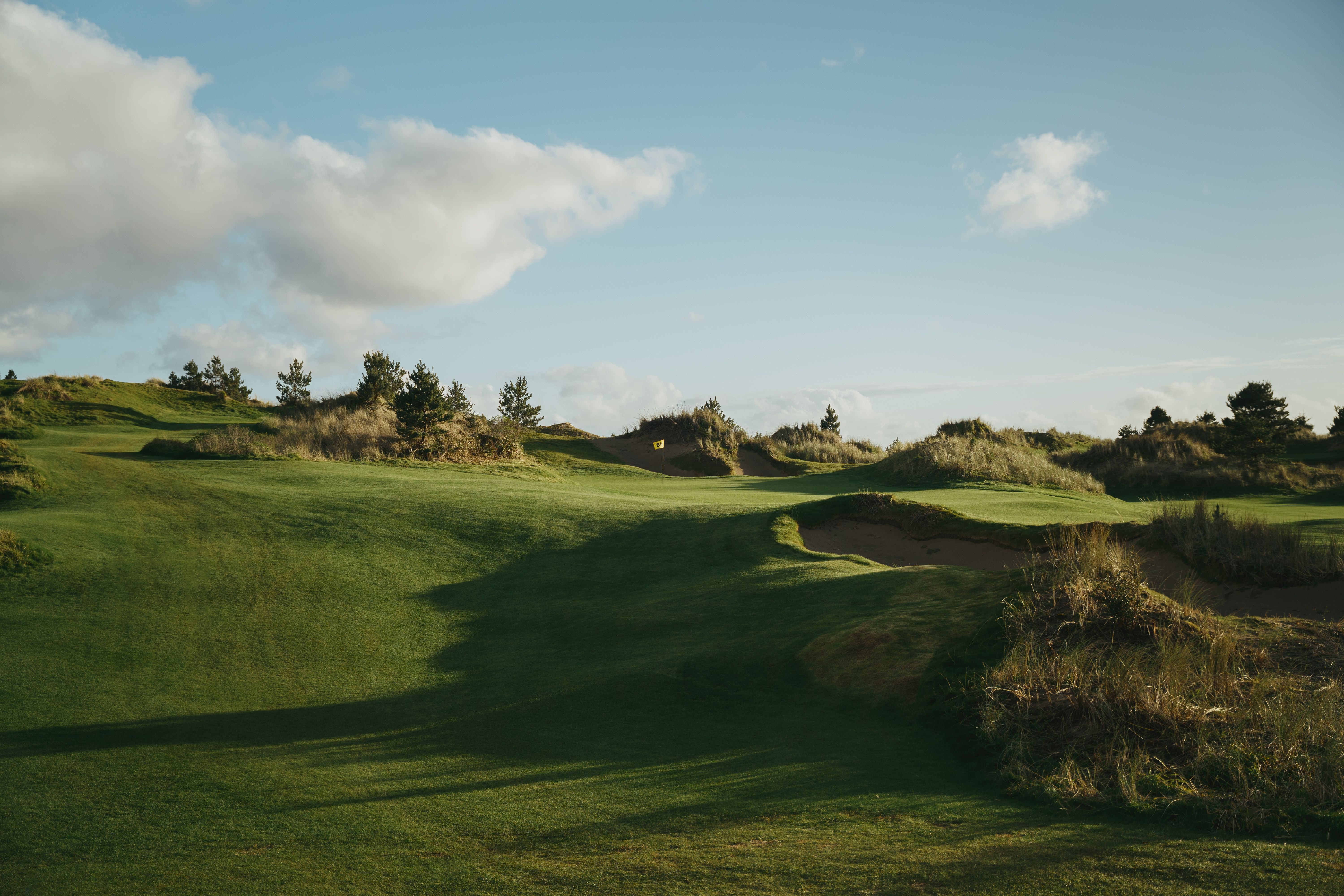 Sunlit Shorty's golf hole winding through grassy dunes