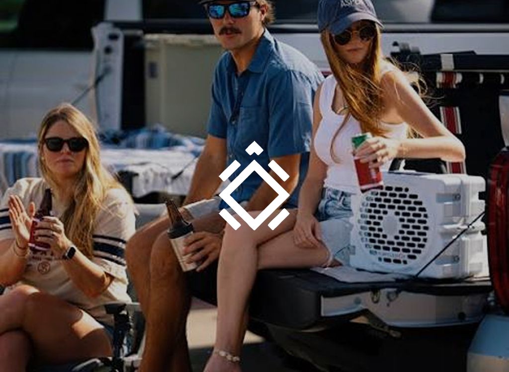 Turtlebox logo over friends drinking beside a speaker on a truck tailgate