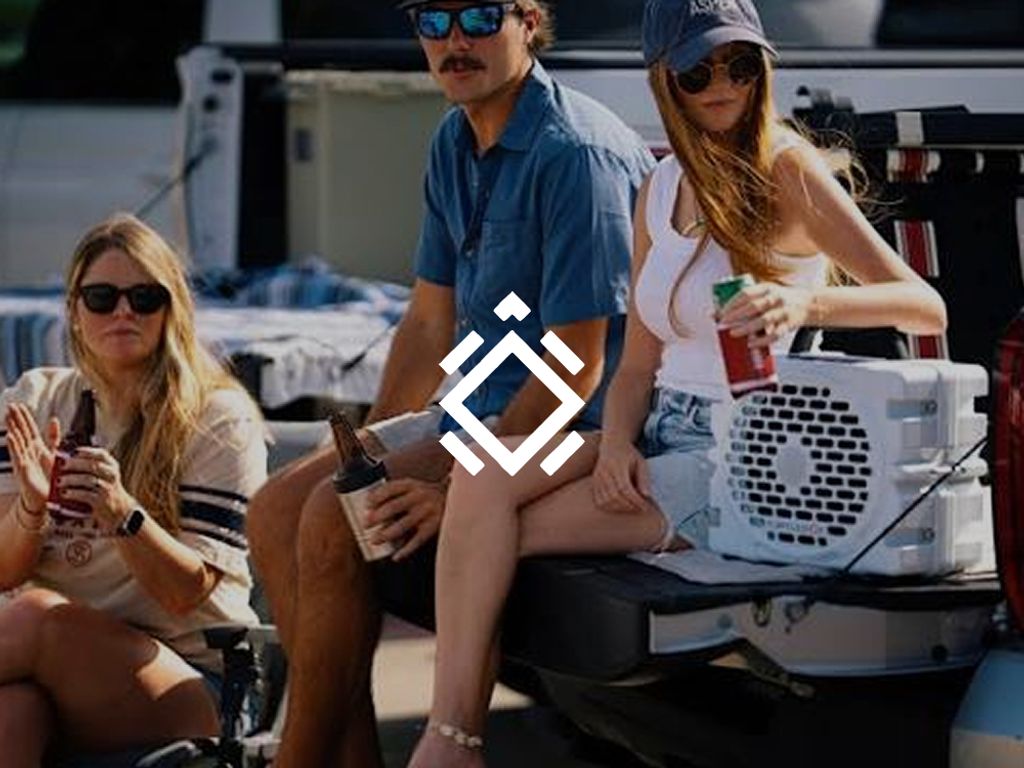 Turtlebox logo over friends drinking beside a speaker on a truck tailgate