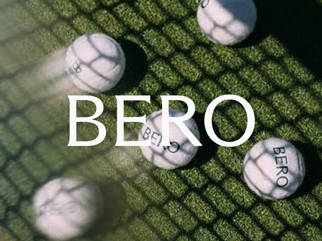 BERO logo over white BERO golf balls on a sunlit grass mat