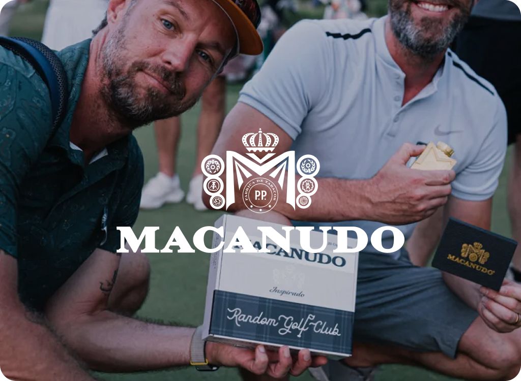 Macanudo logo over two golfers holding a Macanudo Random Golf Club cigar box