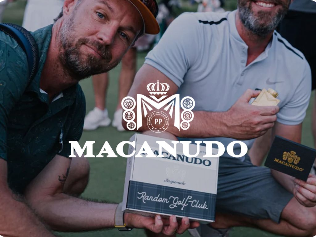 Macanudo logo over two golfers holding a Macanudo Random Golf Club cigar box