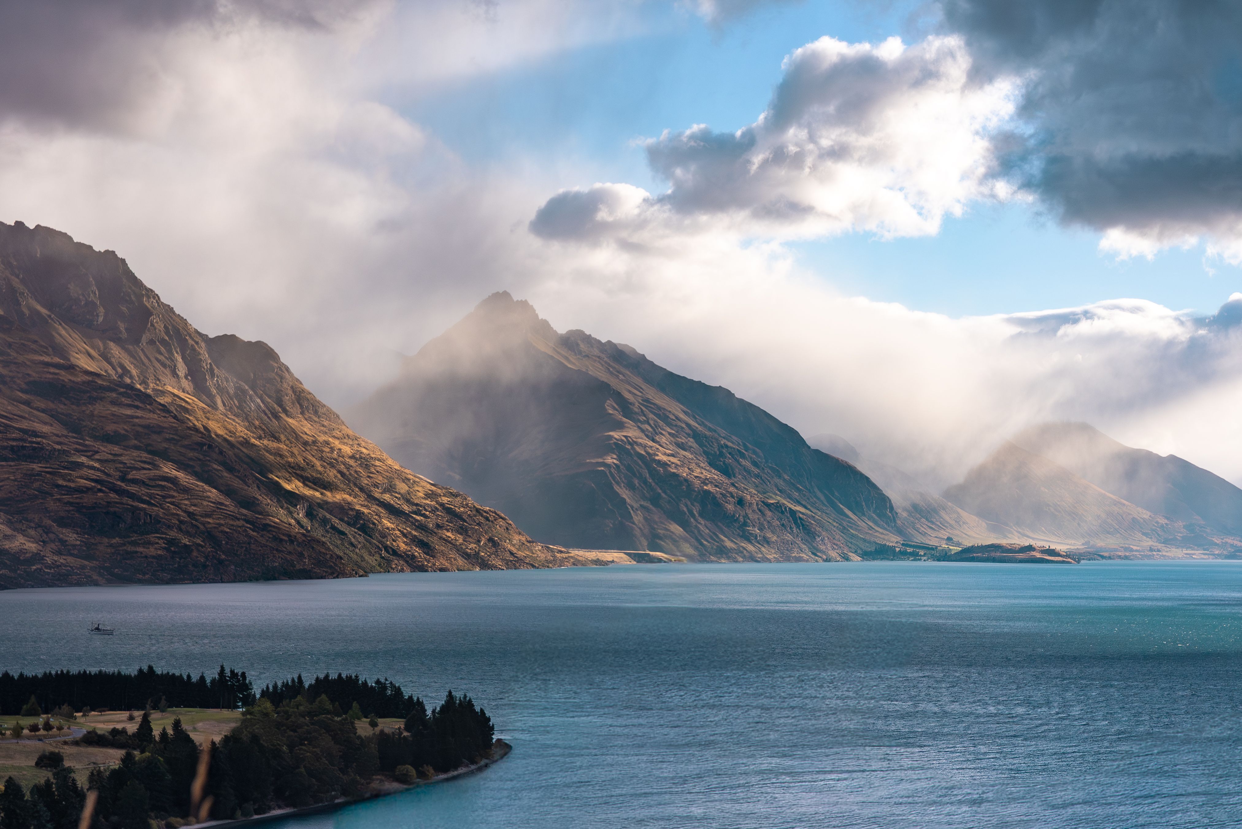 Lake Wakatipu with dramatic mountains and clouds in New Zealand