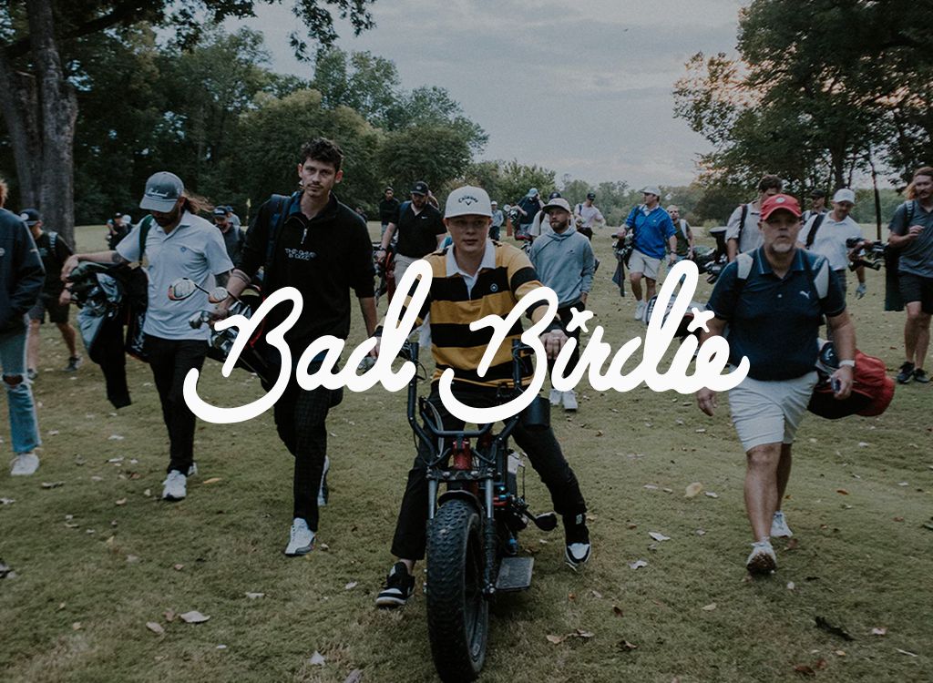 Bad Birdie logo over a golfer on an e-bike leading a crowd across a course