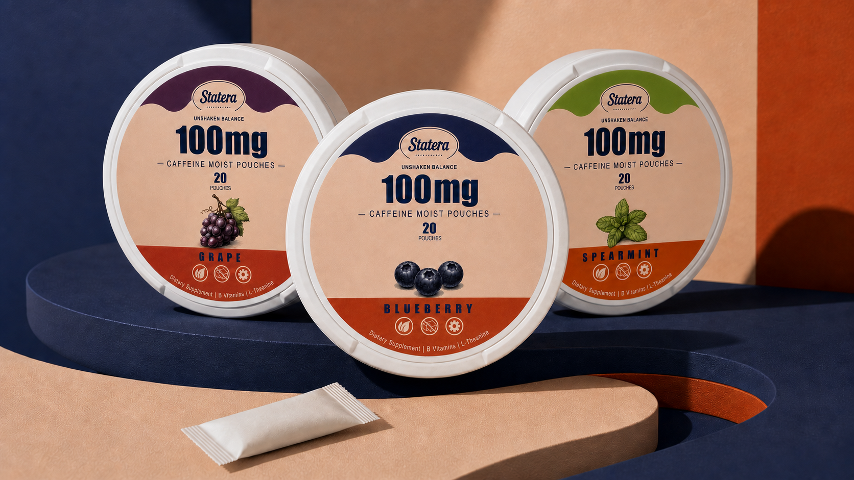 STATERA Grape, Blueberry and Spearmint 100mg caffeine pouch cans with one loose pouch on a sculptural navy and peach editorial set