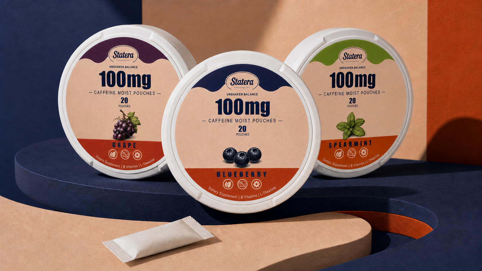 STATERA Grape, Blueberry and Spearmint 100mg caffeine pouch cans with one loose pouch on a sculptural navy and peach editorial set