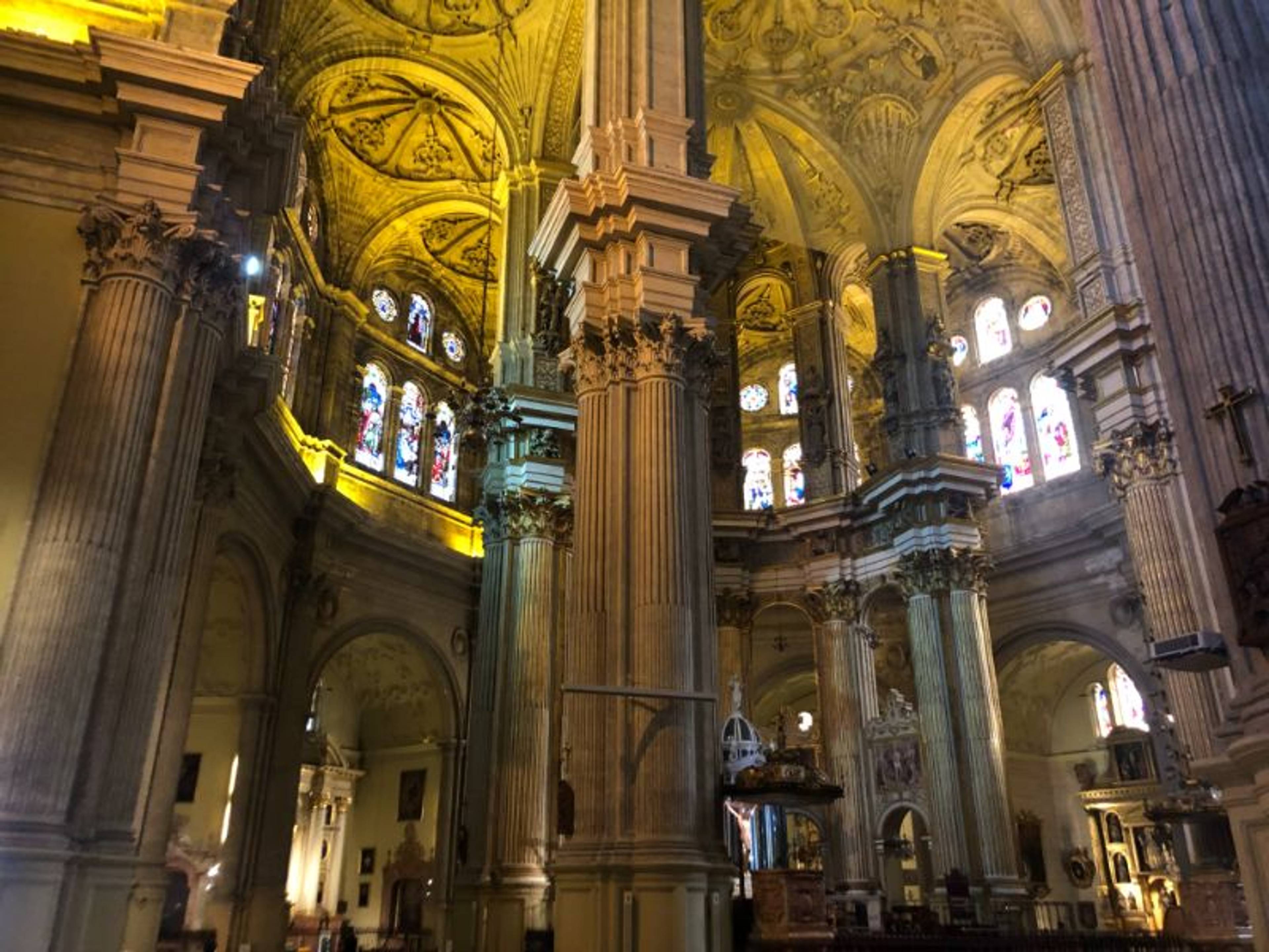 Strzeliste wnętrze kościoła z wysokimi kolumnami i zdobionym sklepieniem