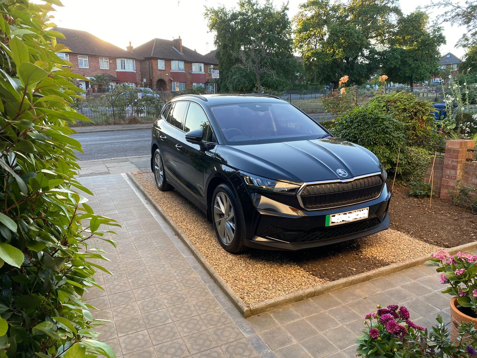 a car parked in a front garden on a newly-created porous surface