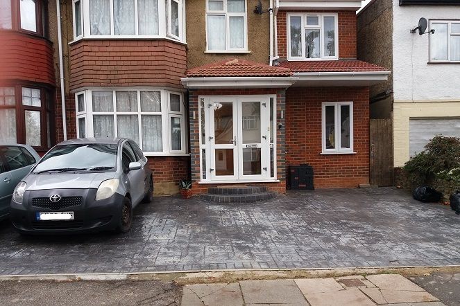 front garden completely covered with sealed bricks and 1 car parked