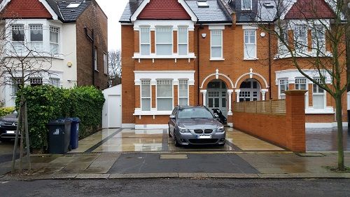 fully paved front garden with 1 car and narrow gap for run off