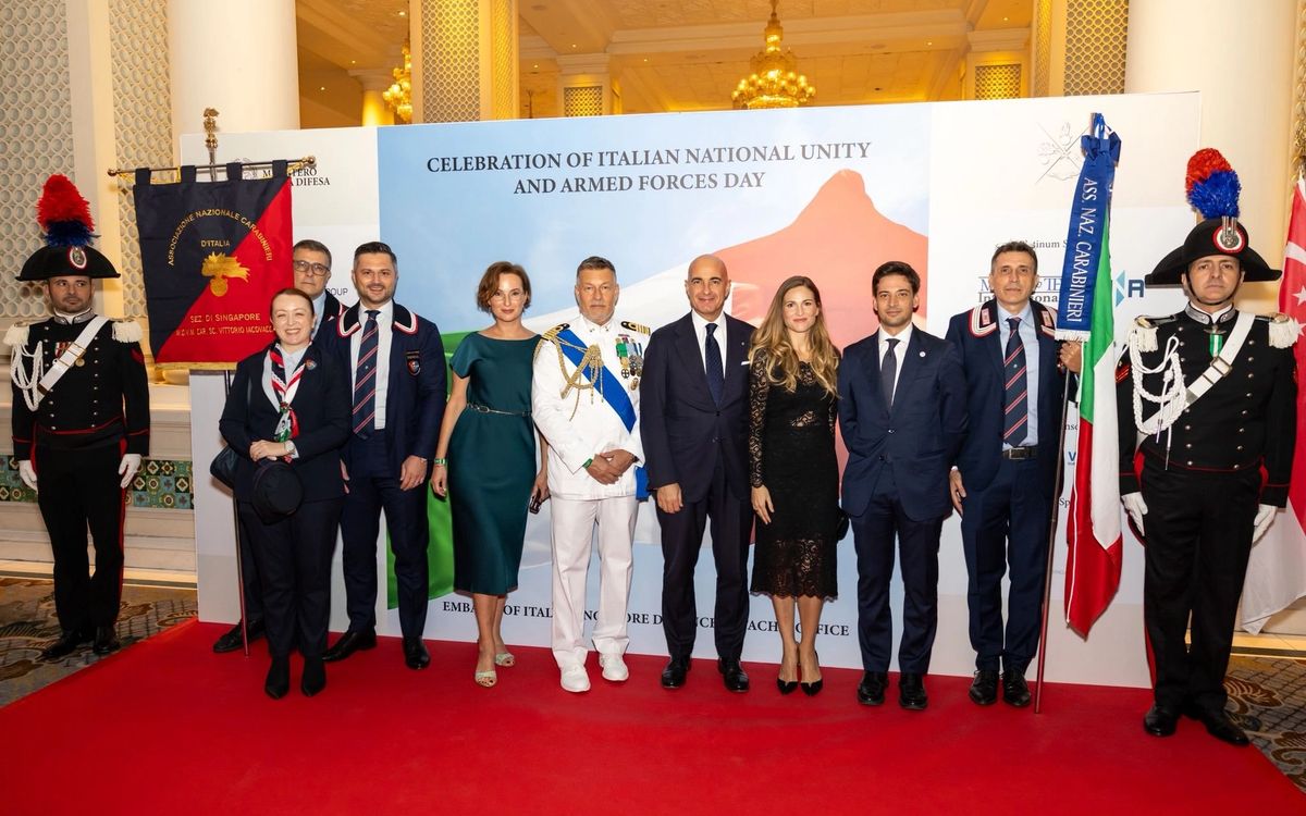 Two Carabinieri in full gala uniform beside ANC Singapore members and guests at the celebration of Italian National Unity and Armed Forces Day.