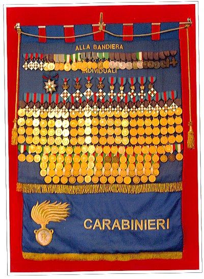 Blue banner covered with rows of gold and silver medals above the word Carabinieri.