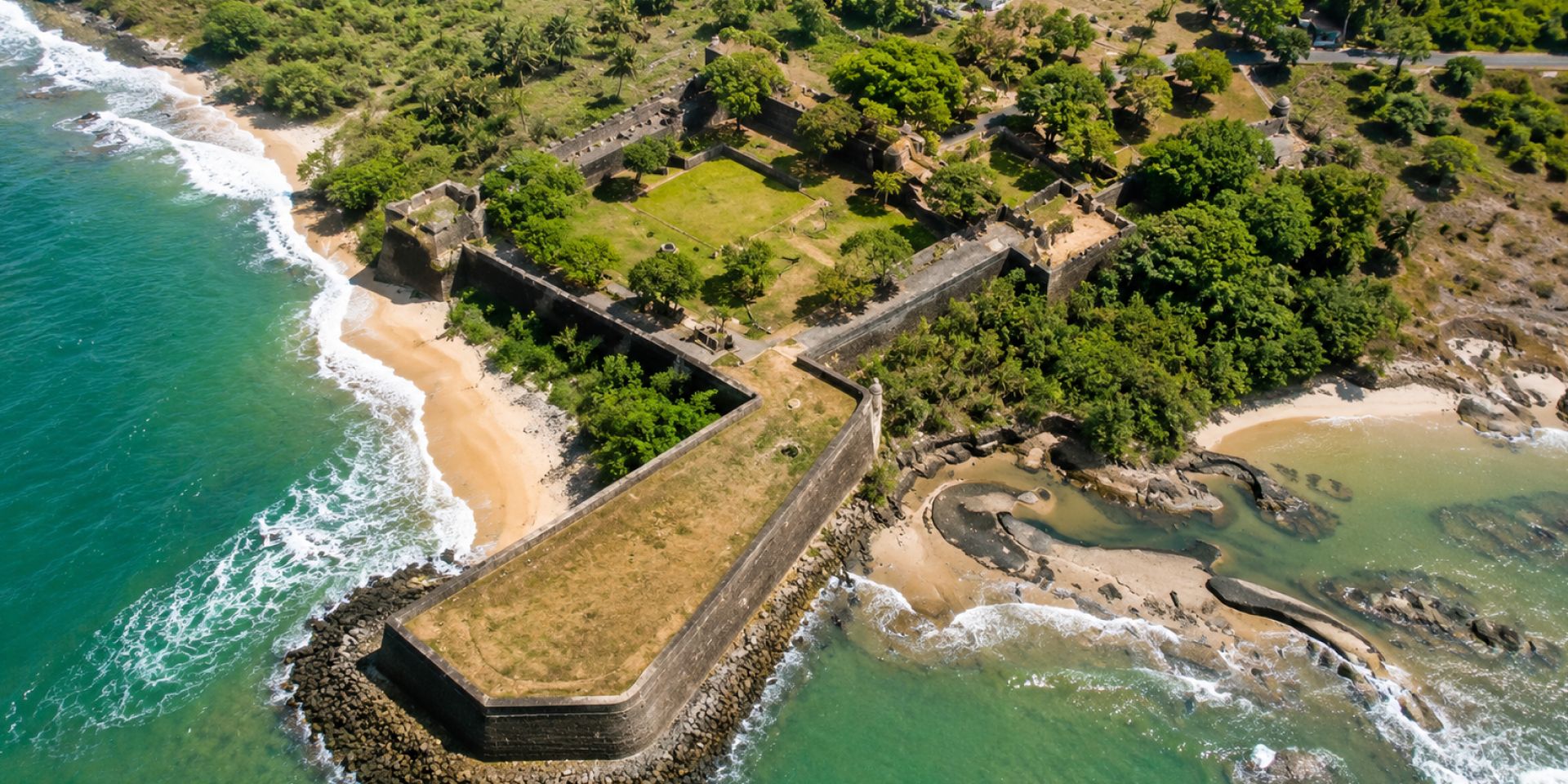 Granite sea ramparts and lawn precincts of 18th-century Vattakottai Fort