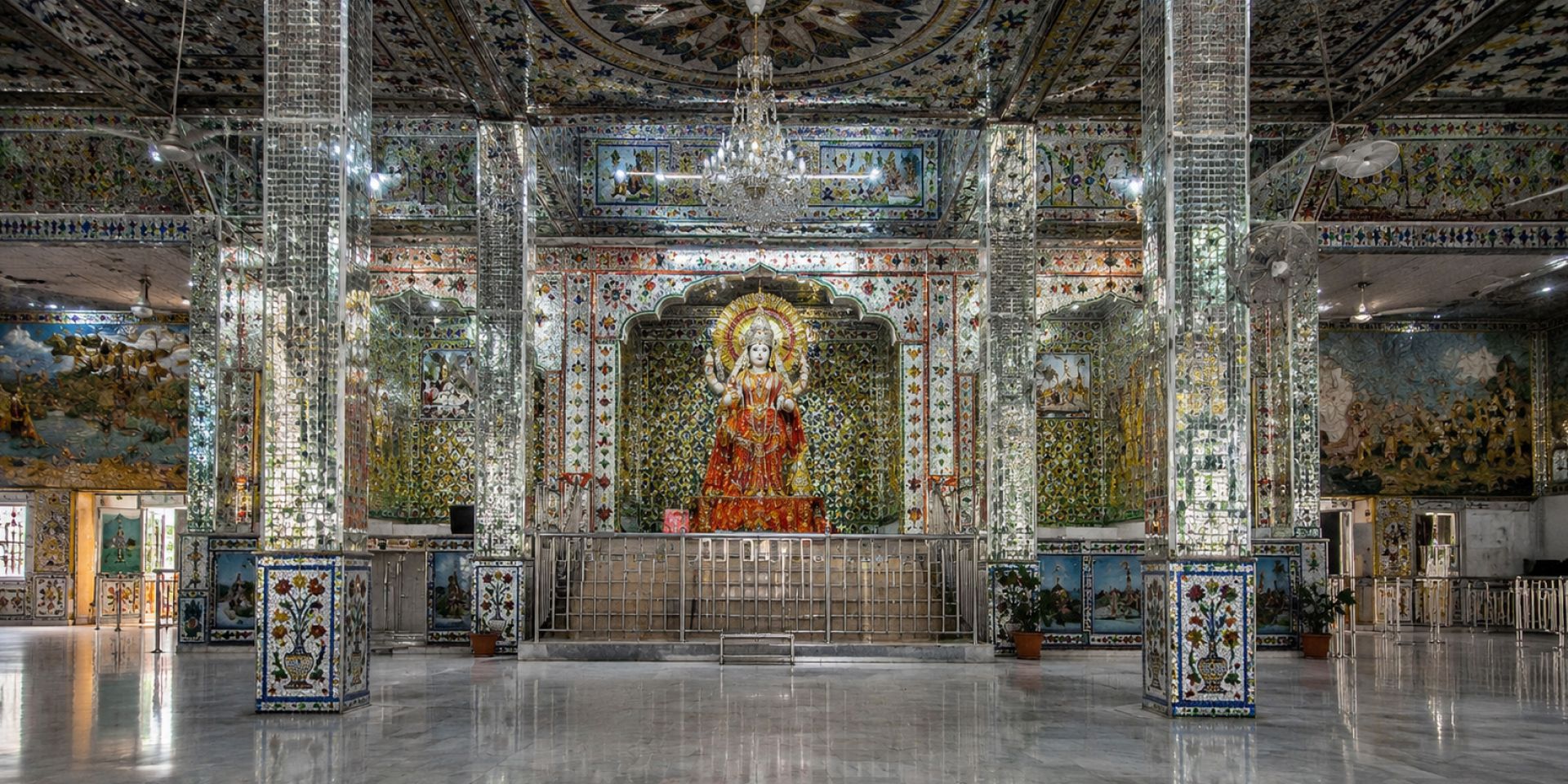 Bustling narrow old-city bazaar street lined with brassware and sweet shops in Haridwar