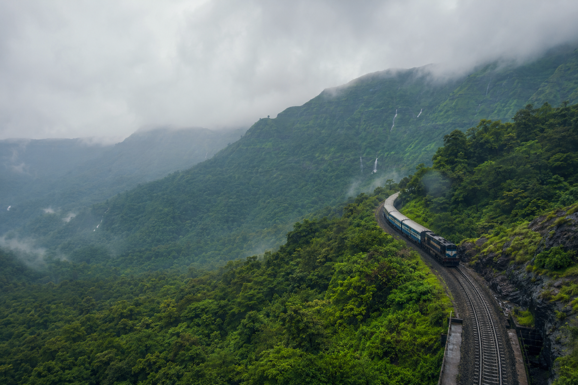 Traveler overlooking India's diverse landscapes featuring mountains, deserts, temples, heritage architecture and coastline during sunrise