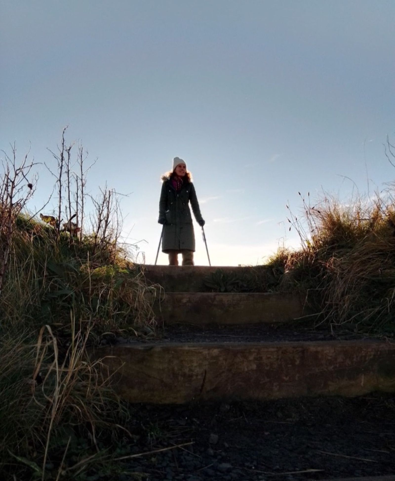 Gina at the top of a set of steps at first light