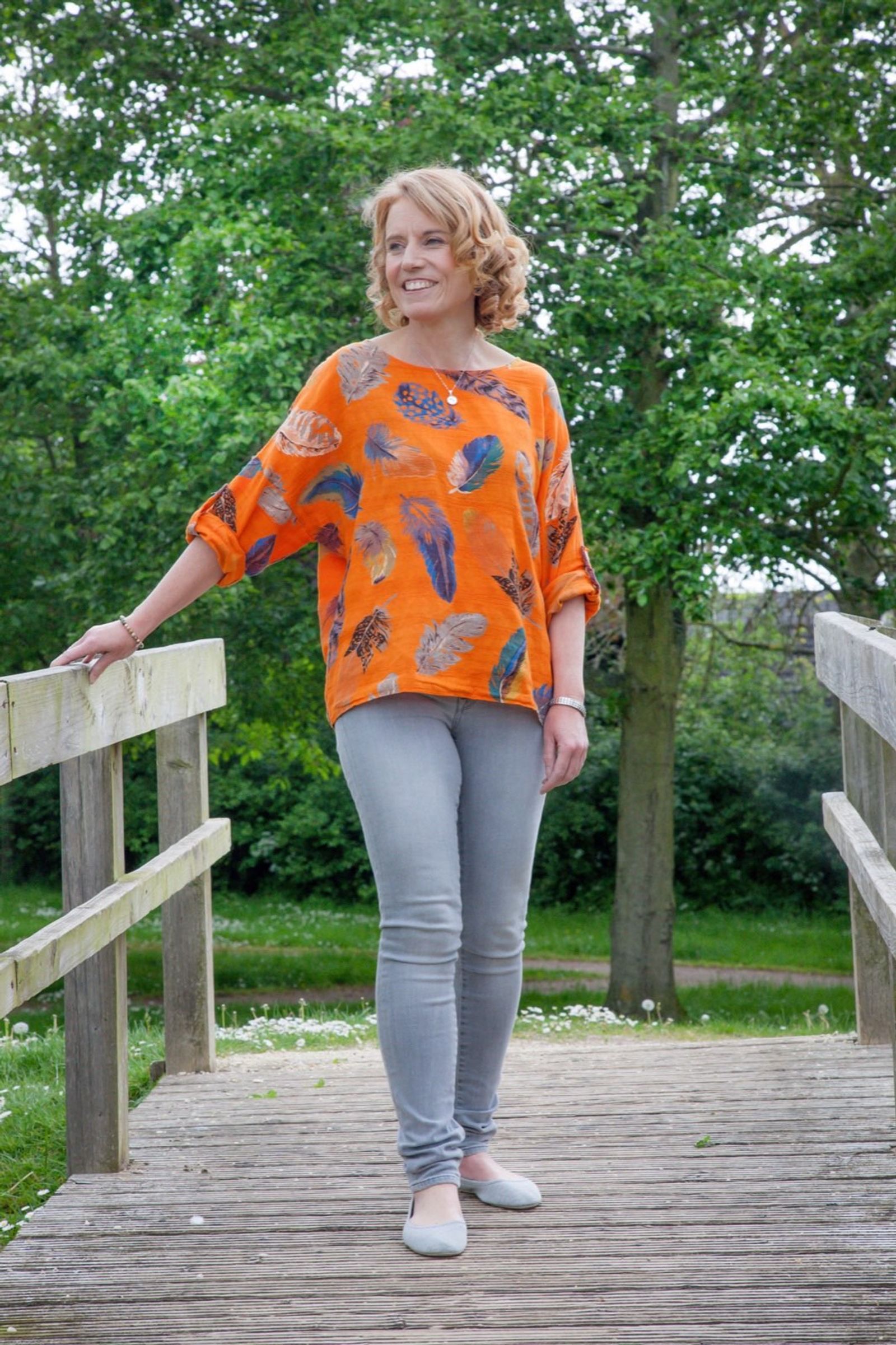 Gina on a bridge surrounded by trees