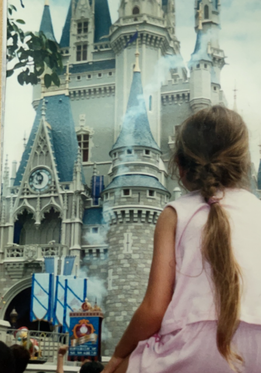 Princess Aurora with a face-painted birthday girl in a blue princess dress