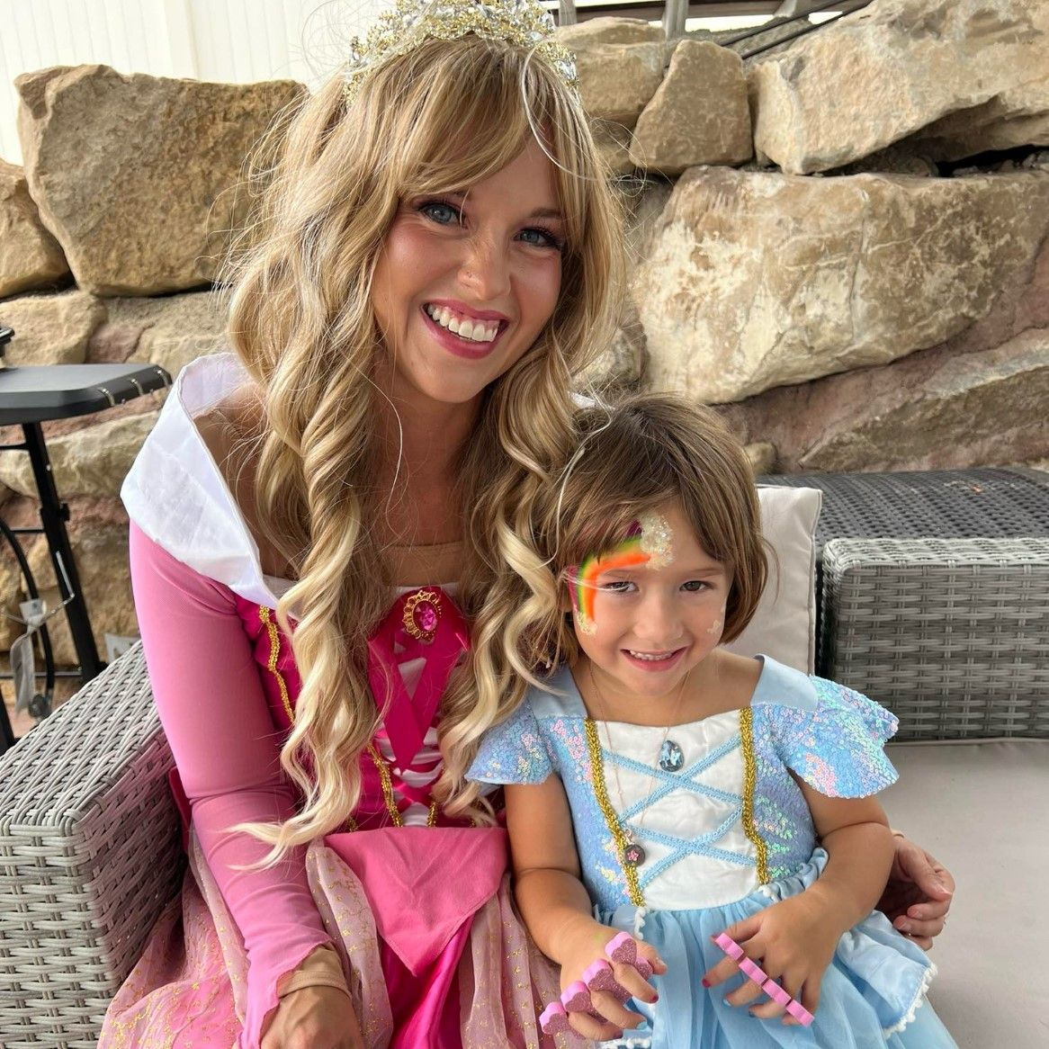 Princess character posing with a child who just got her nails done