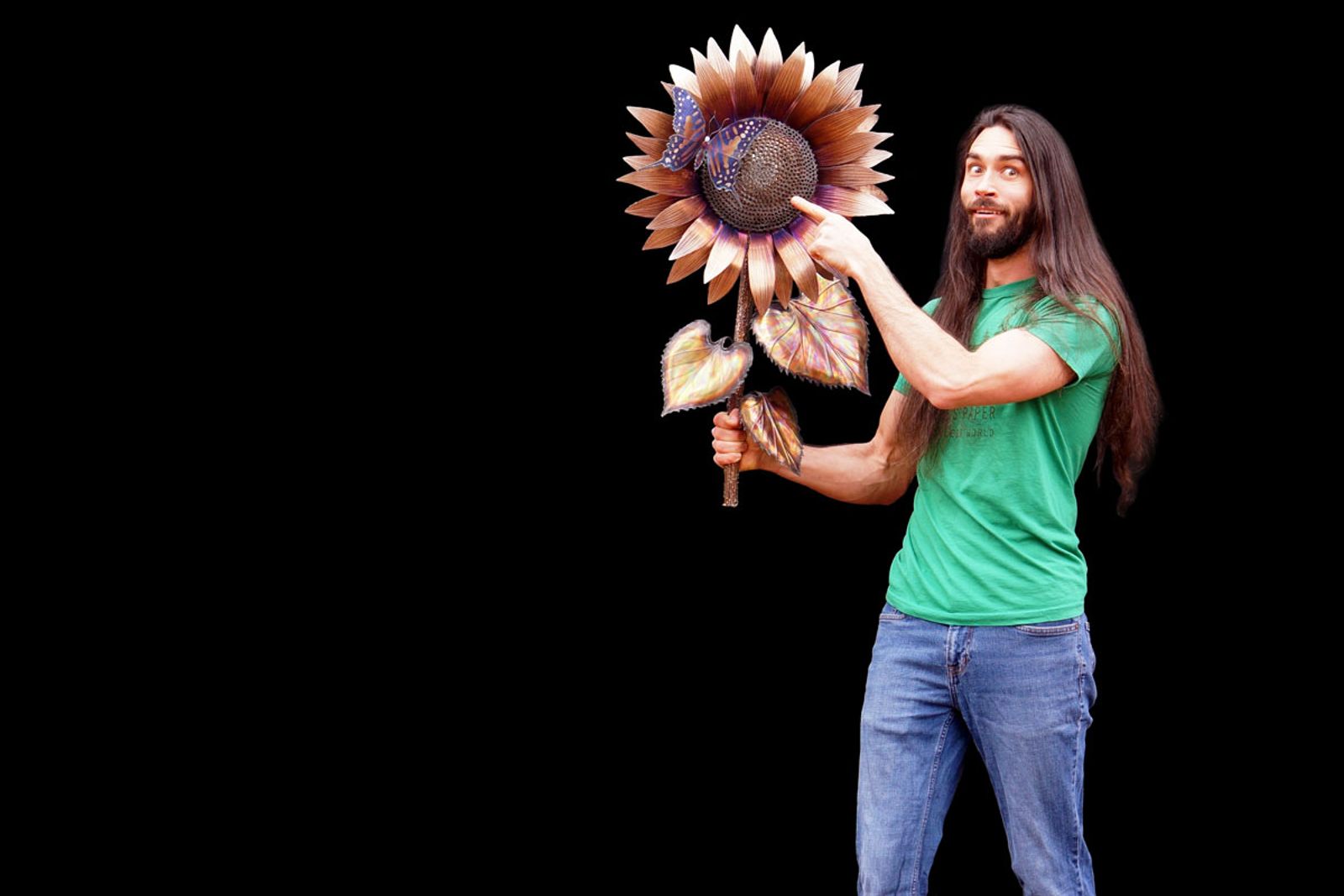 Artist Aiden Dale spotting a butterfly on stainless steel sunflower sculpture