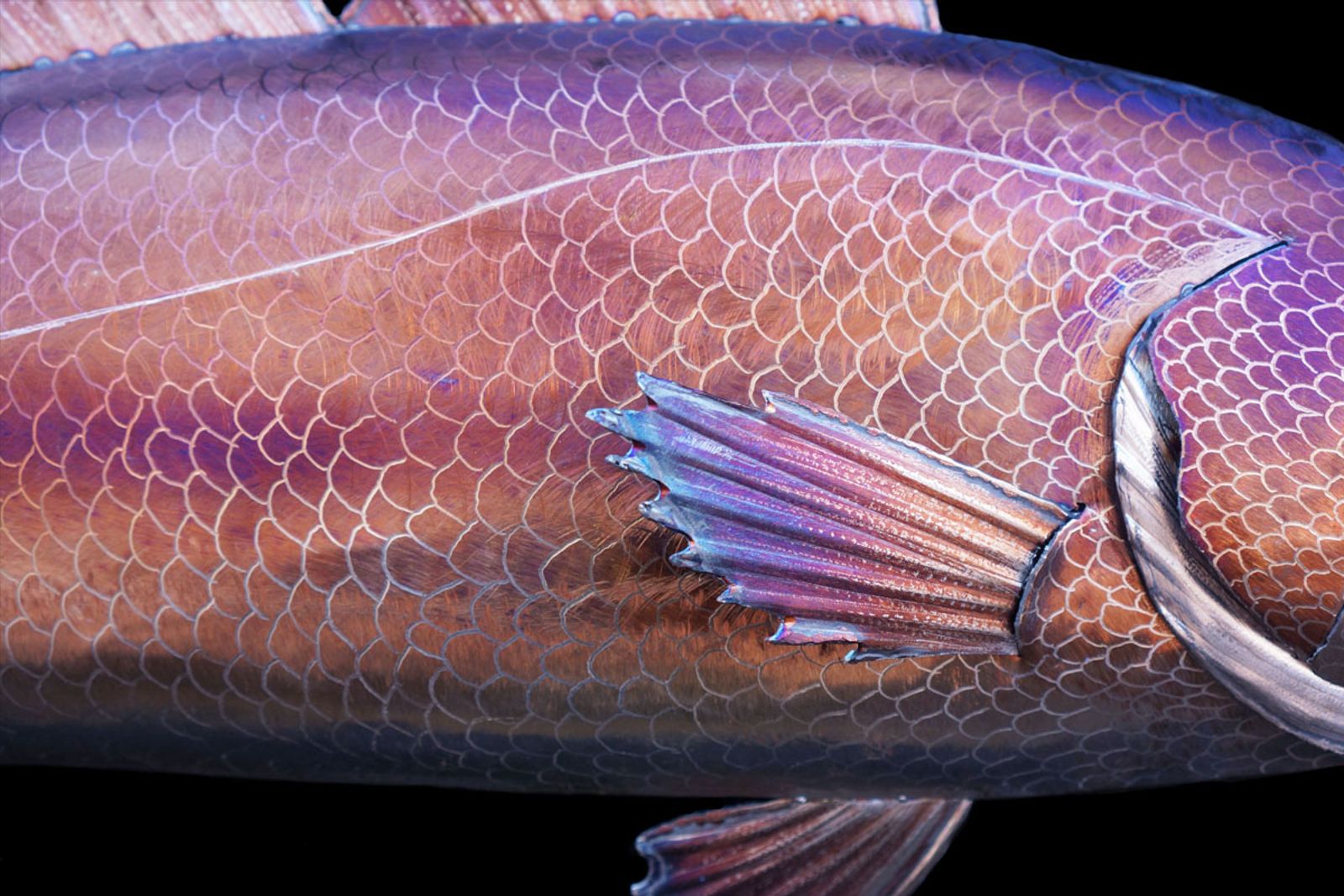 Close up of metal red drum sculptures scale pattern