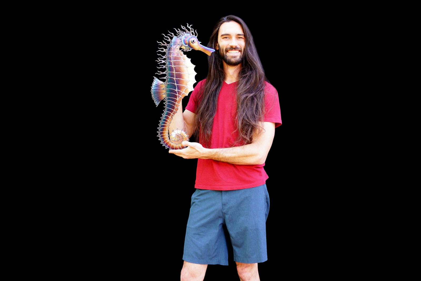 sculptor Aiden Dale with his metal spiny seahorse sculpture.