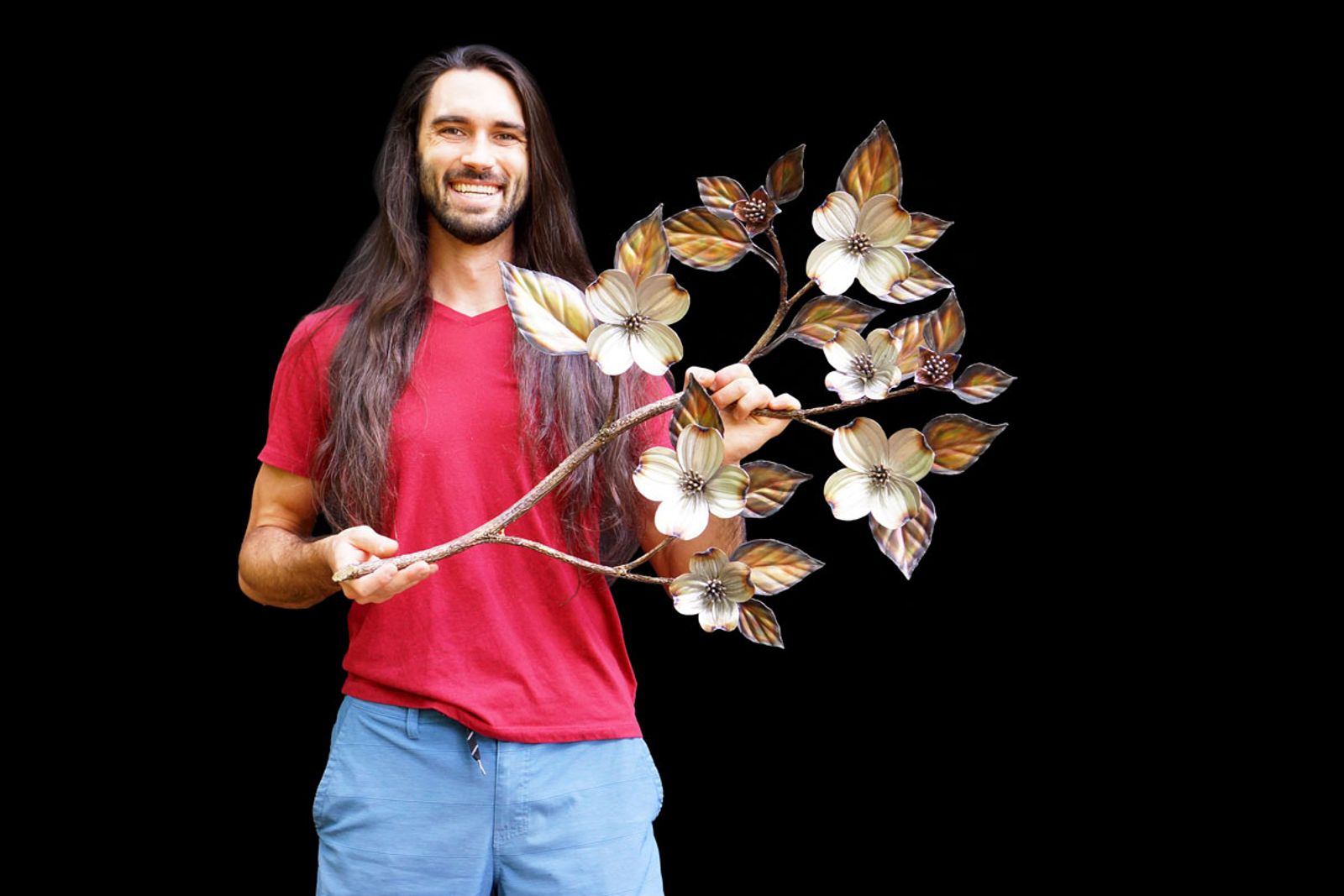 Artist Aiden Dale with his medium sized metal dogwood sculpture