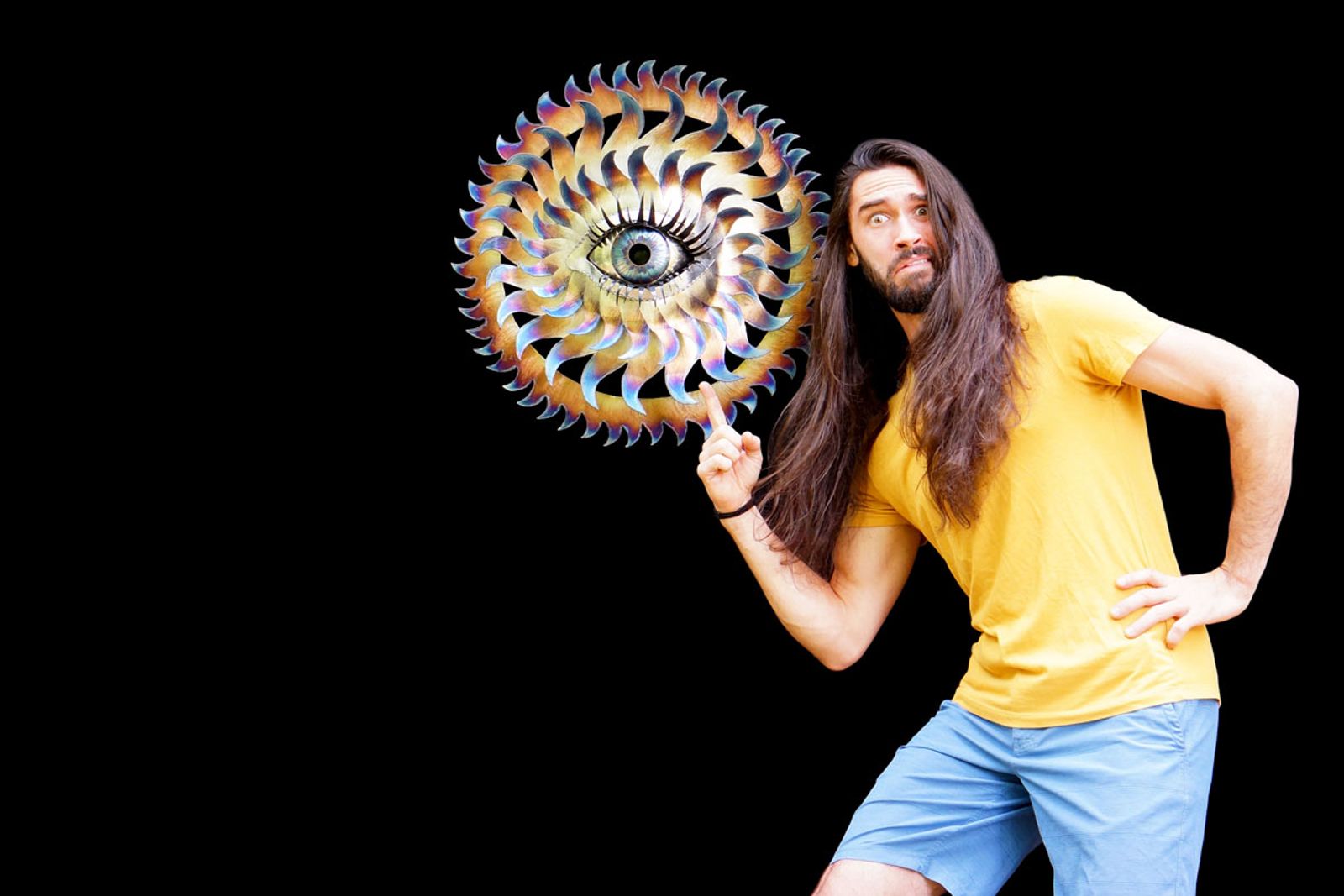 Artist Aiden Dale with stainless steel flowering eye sculpture