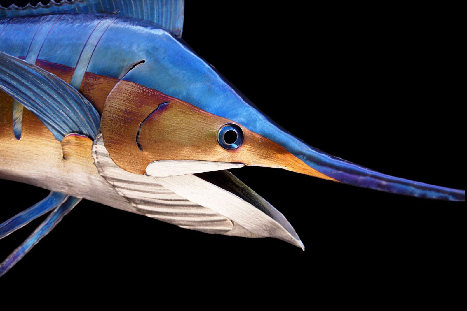 Closeup of small blue marlin metal sculpture.
