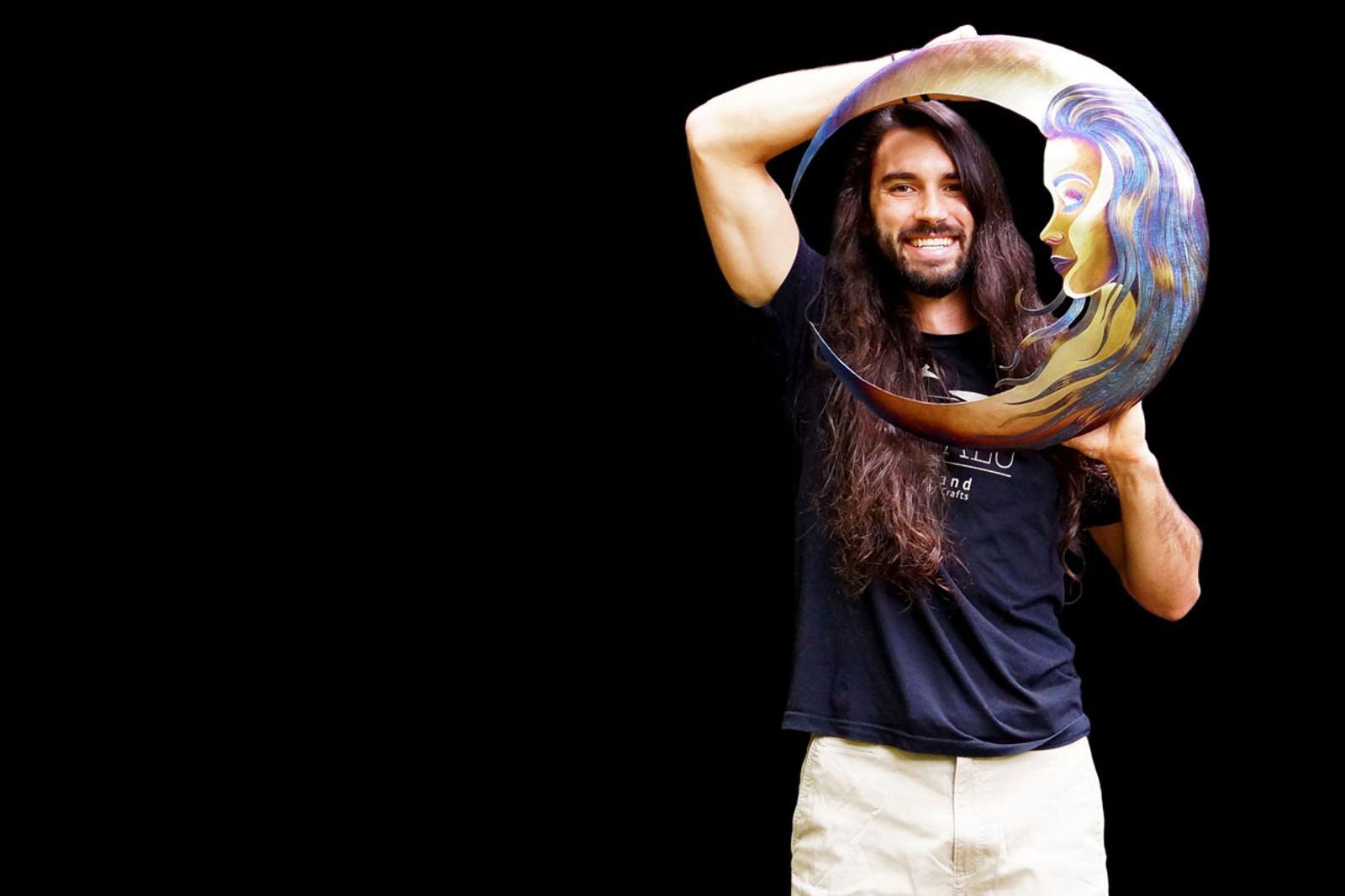 Artist Aiden Dale with stainless steel moon lass sculpture