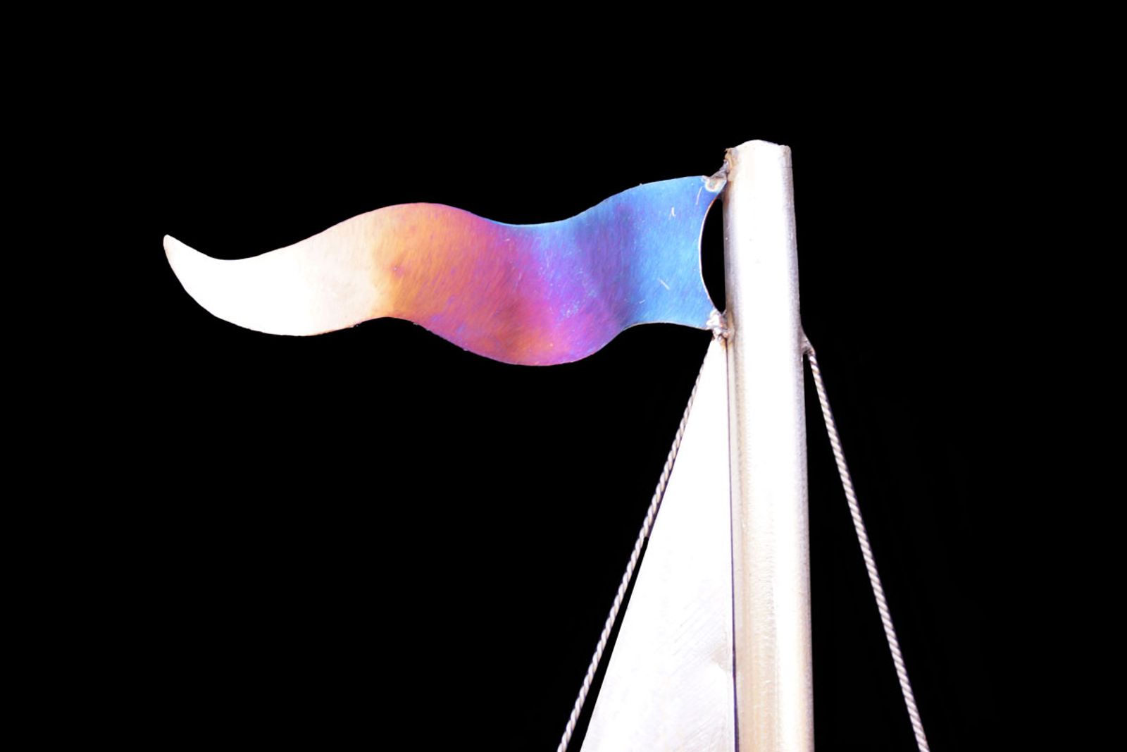 Closeup of sailboat sculptures flag.