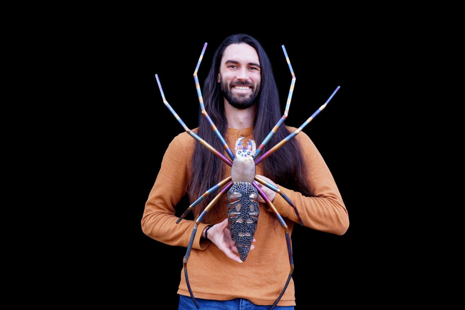Sculptor Aiden Dale with his metal orb weaver spider sculpture