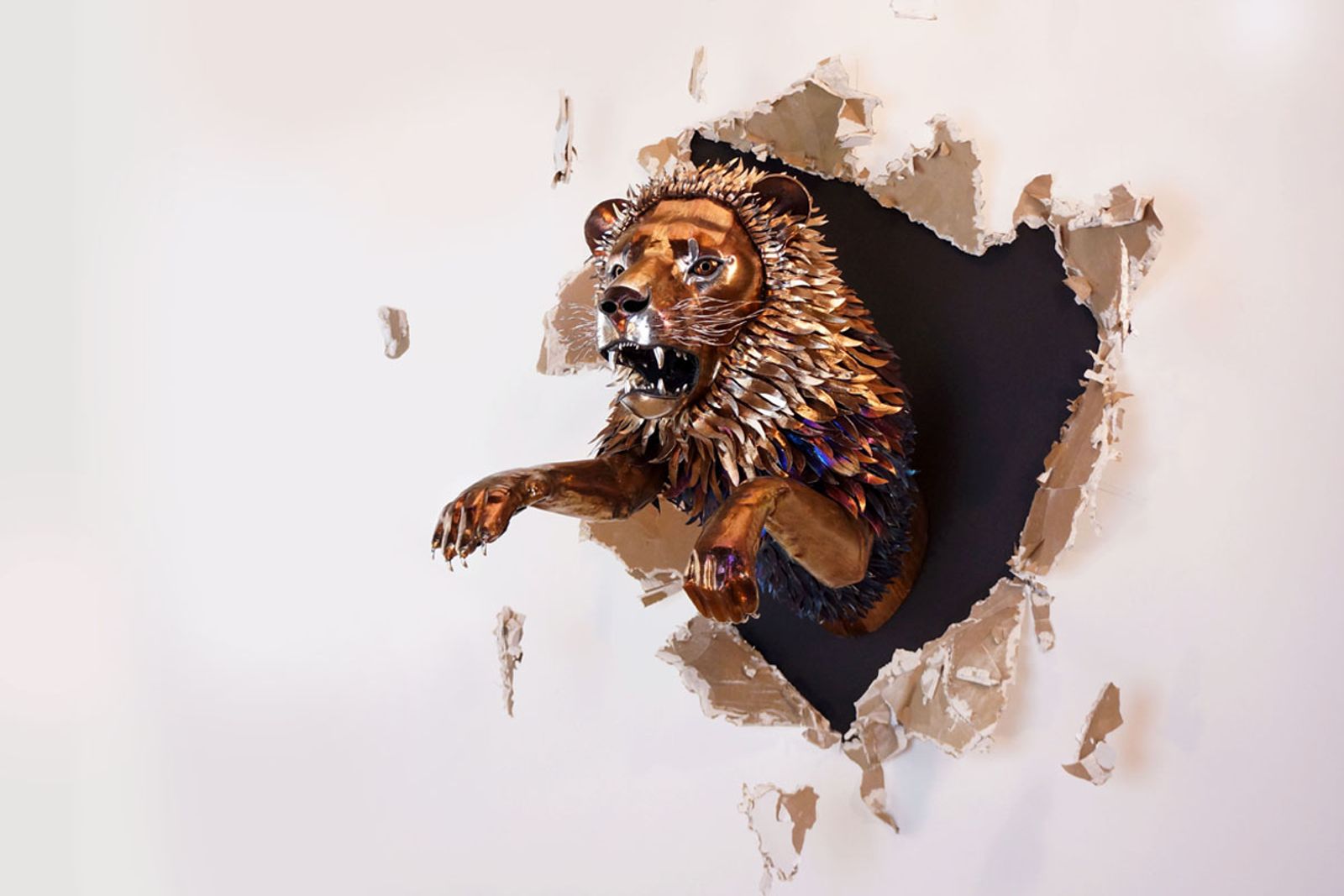 Metal lion sculpture side view.