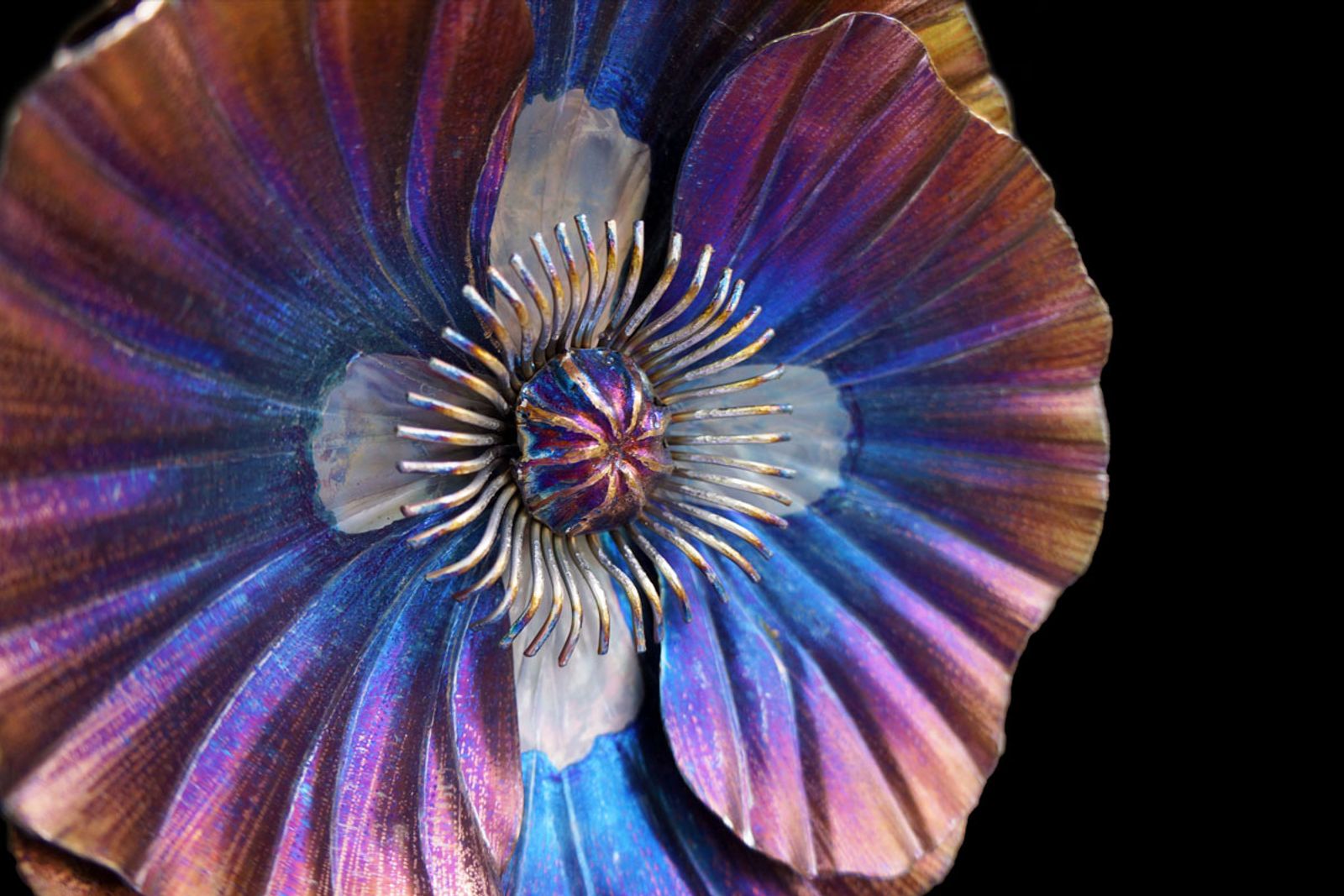 Macro close-up of welded poppy seed pod and intricate hand-bent stainless steel stamens with fine grinder detailing.