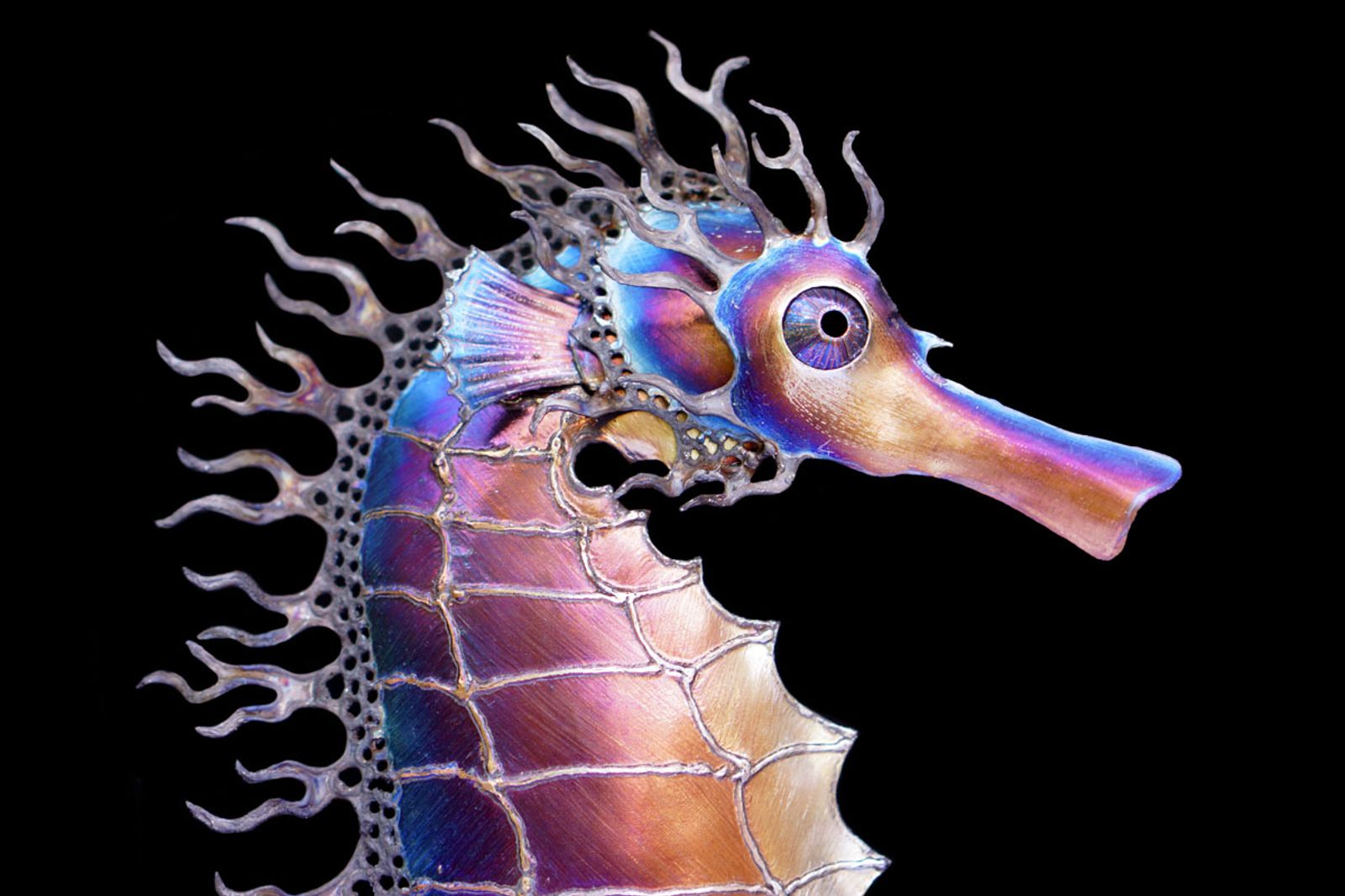 Closeup of metal spiny seahorse sculpture's head.