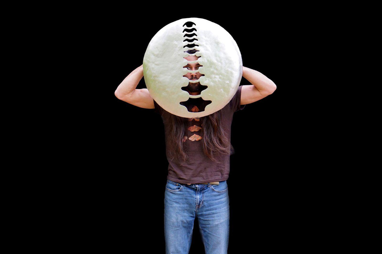 Artist Aiden Dale peeking through Sterling Chiropractic Sign.