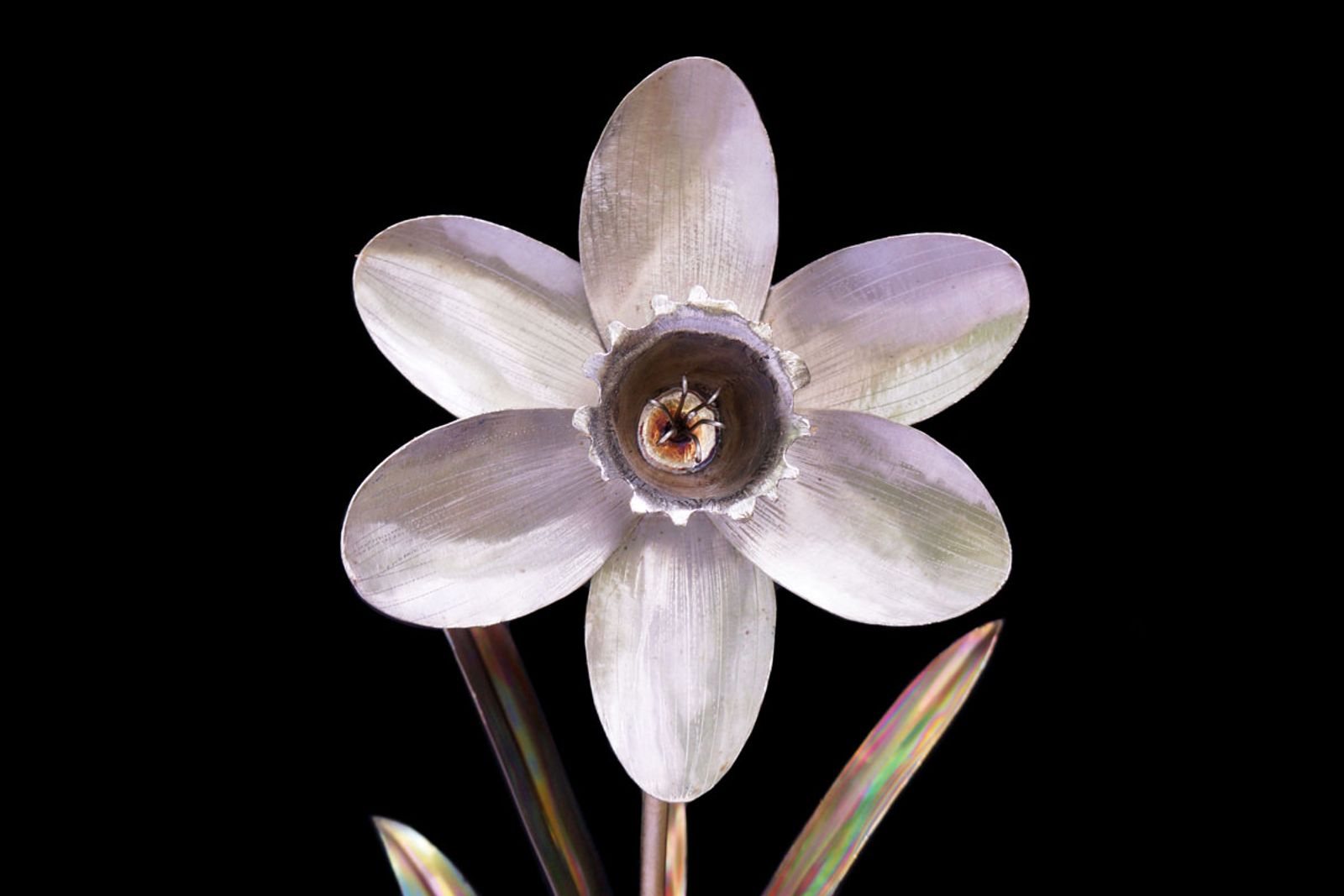 Detailed view of the stainless steel daffodil bloom, showing polished silver petals with natural metal shine.