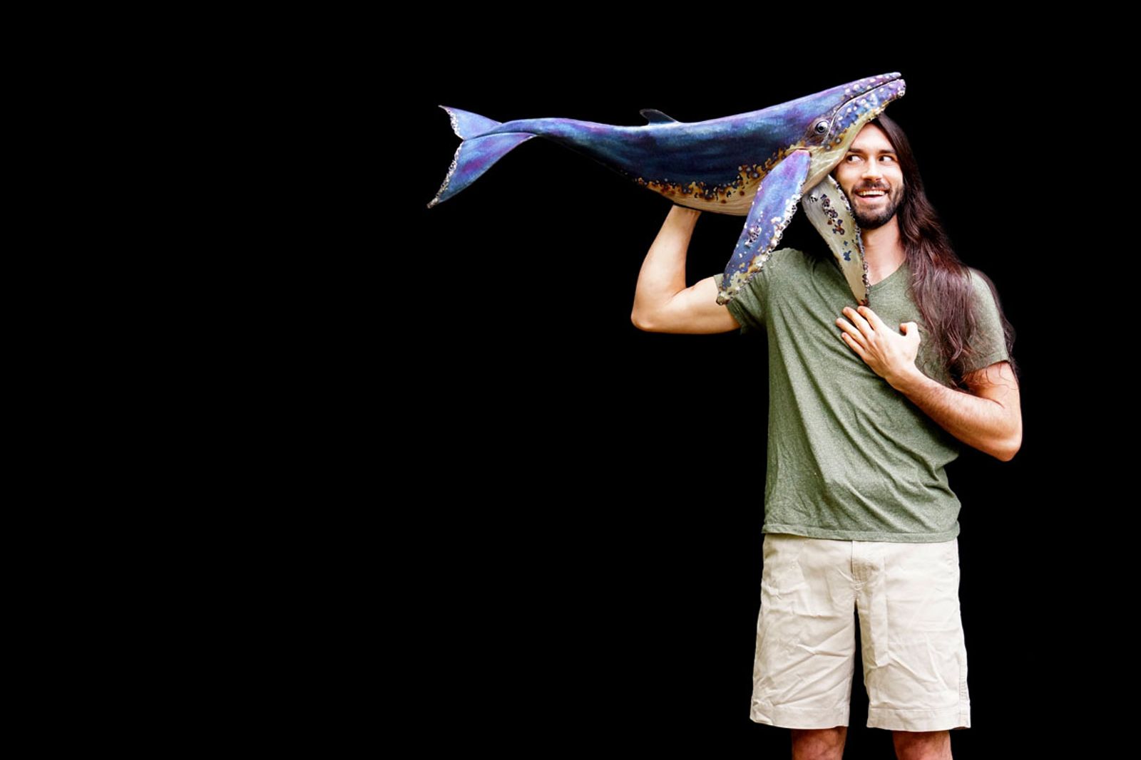 Sculptor Aiden Dale with his metal humpback whale sculpture