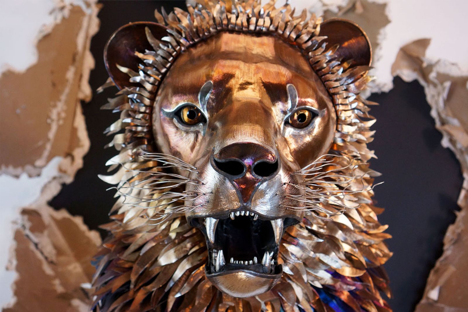 Closeup of lion metal lion sculpture's face.