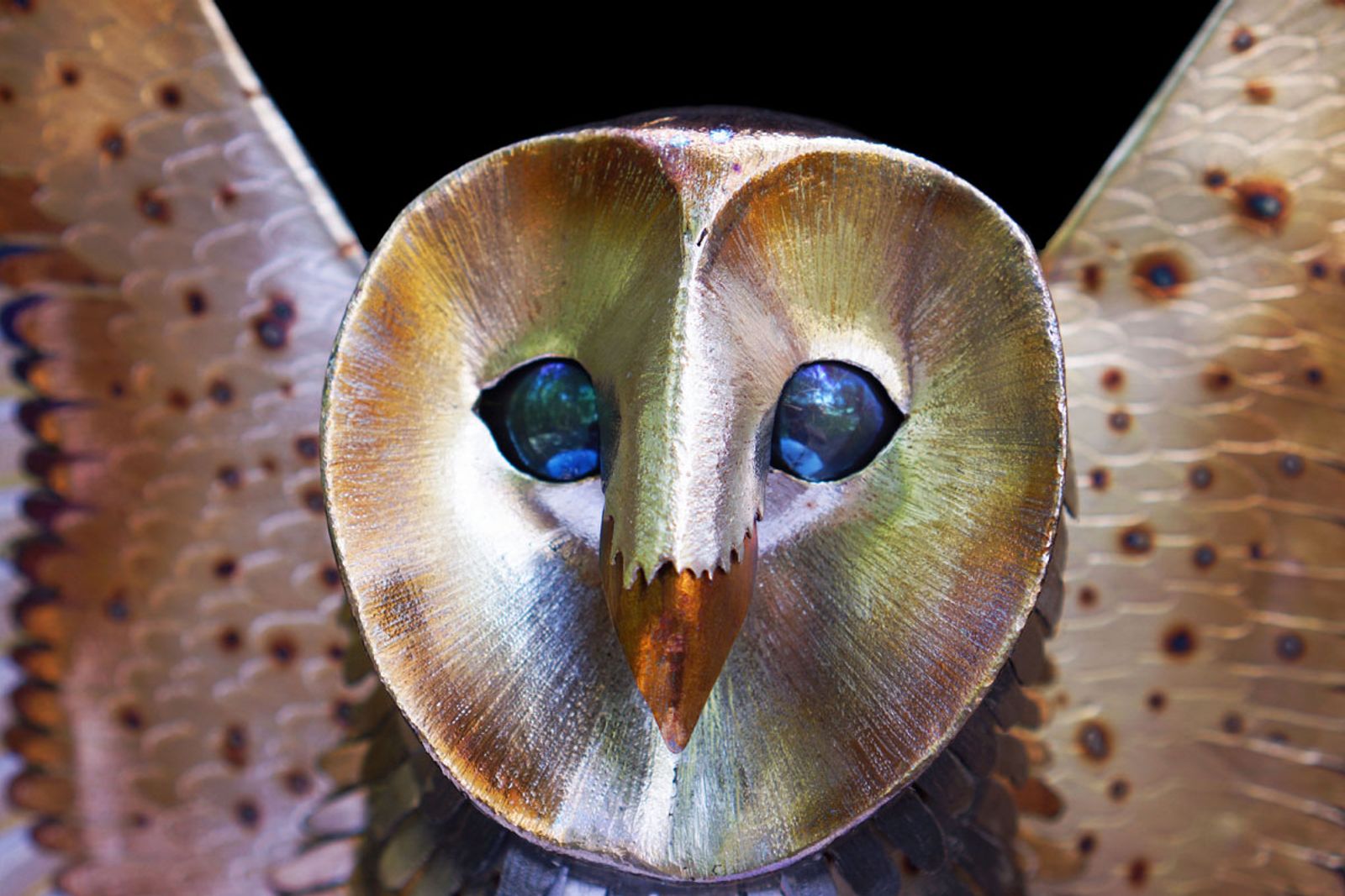 Closeup of barn owl sculptures face.