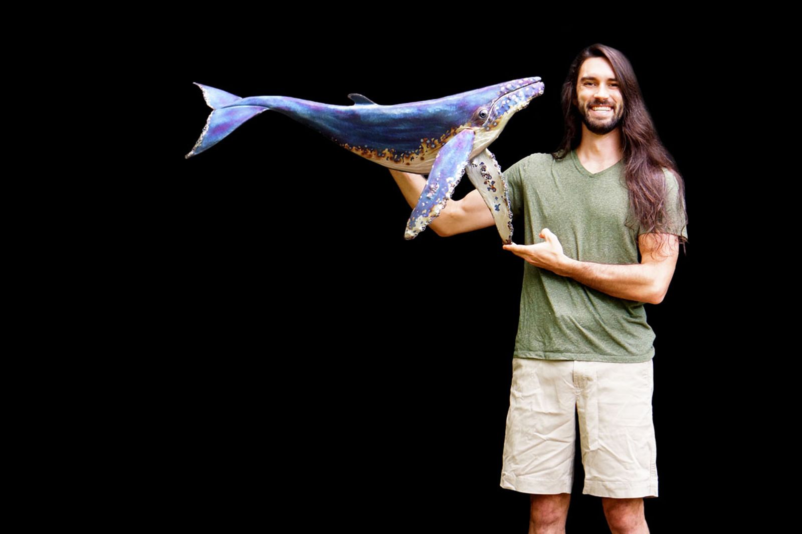 Artist Aiden Dale with stainless steel humpback whale sculpture