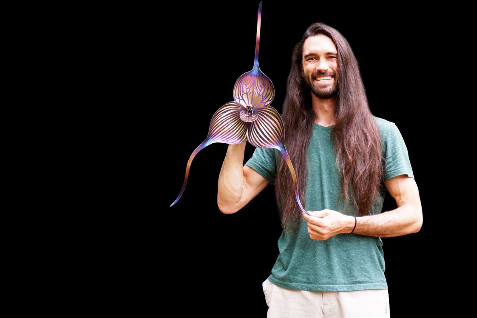 Artist Aiden Dale with his metal Dracula orchid sculpture.
