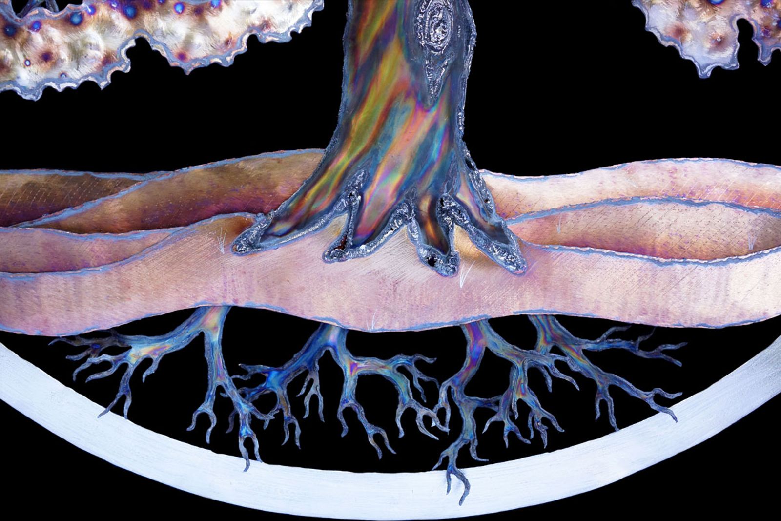 Closeup of roots from metal tree of life sculpture.