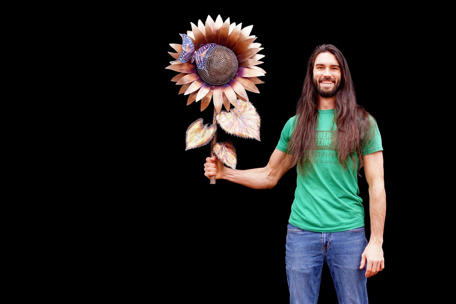 Artist Aiden Dale with metal sunflower with butterfly sculpture