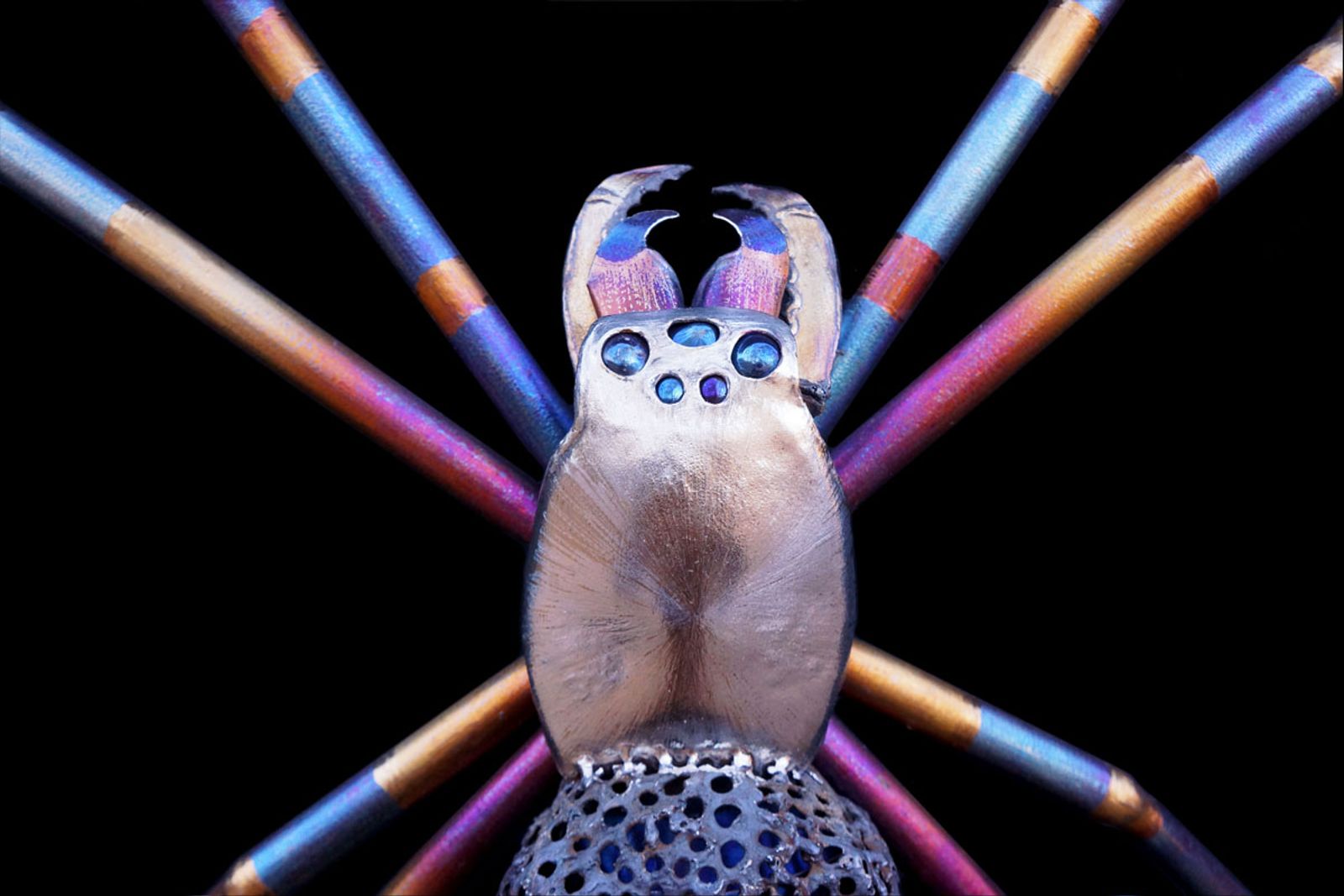 Closeup or metal yellow garden spider sculpture's face.