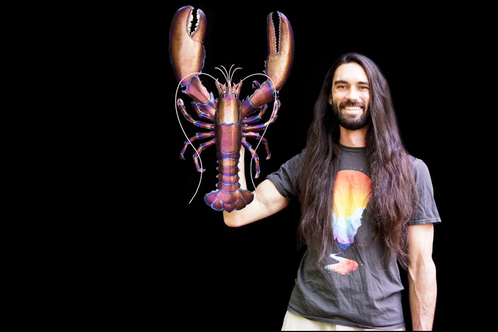 Sculptor Aiden Dale with his red lobster metal sculpture.