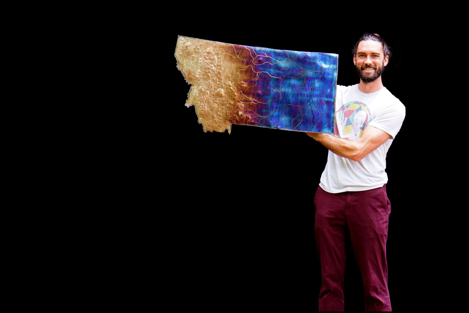Artist Aiden Dale with large montana map sculpture
