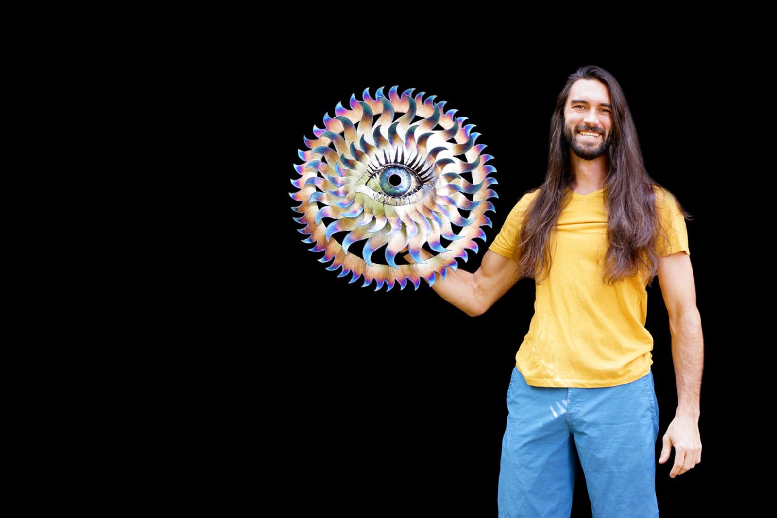 Artist Aiden Dale with metal flowering eye sculpture